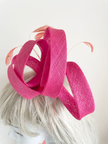 TAILOR MADE PINK STRAW COILS & CORAL FEATHER FASCINATOR ON COMB