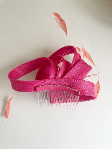 TAILOR MADE PINK STRAW COILS & CORAL FEATHER FASCINATOR ON COMB