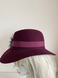 UNBRANDED BURGUNDY FELTED WOOL HAND TRIMMED TRILBY HAT WITH NAVY FEATHERS SIZE APPROX S/M