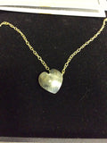 AN ORIGINAL GRACIE MAY OXIDISED SILVER HEART ON A GOLD CHAIN