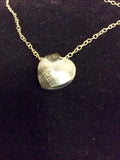 AN ORIGINAL GRACIE MAY OXIDISED SILVER HEART ON A GOLD CHAIN